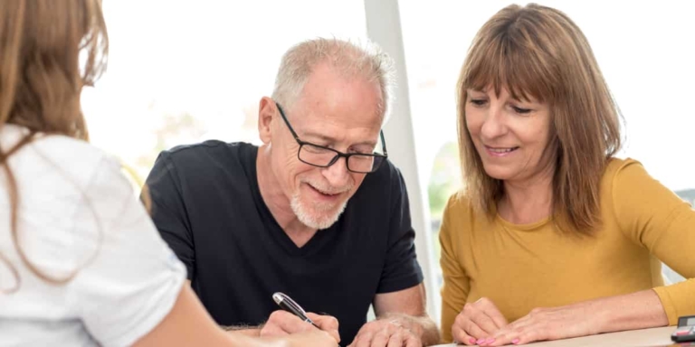 A couple signing an estate plan.