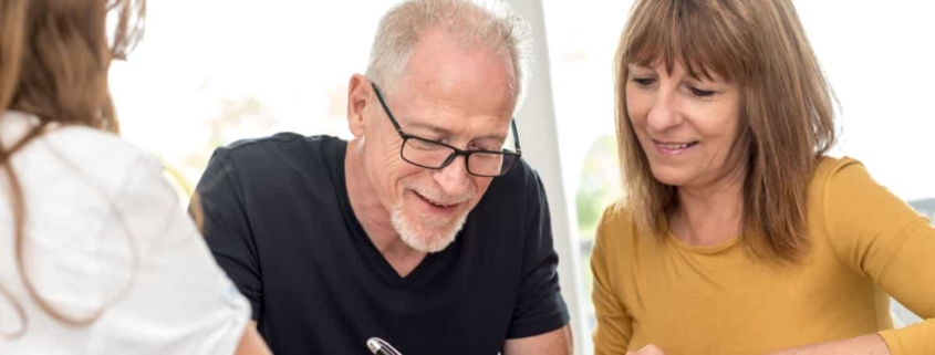 A couple signing an estate plan.