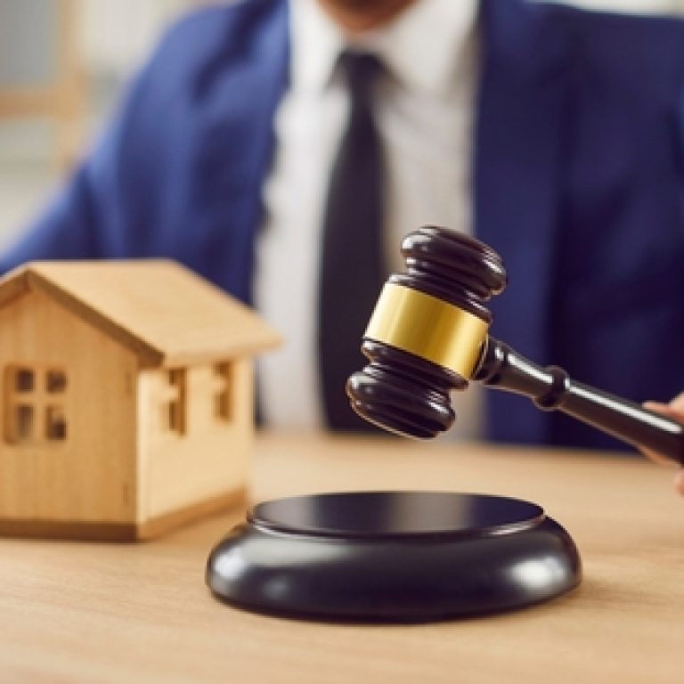 Male,Judge,Sitting,At,Desk,With,Gavel,And,Small,Wooden