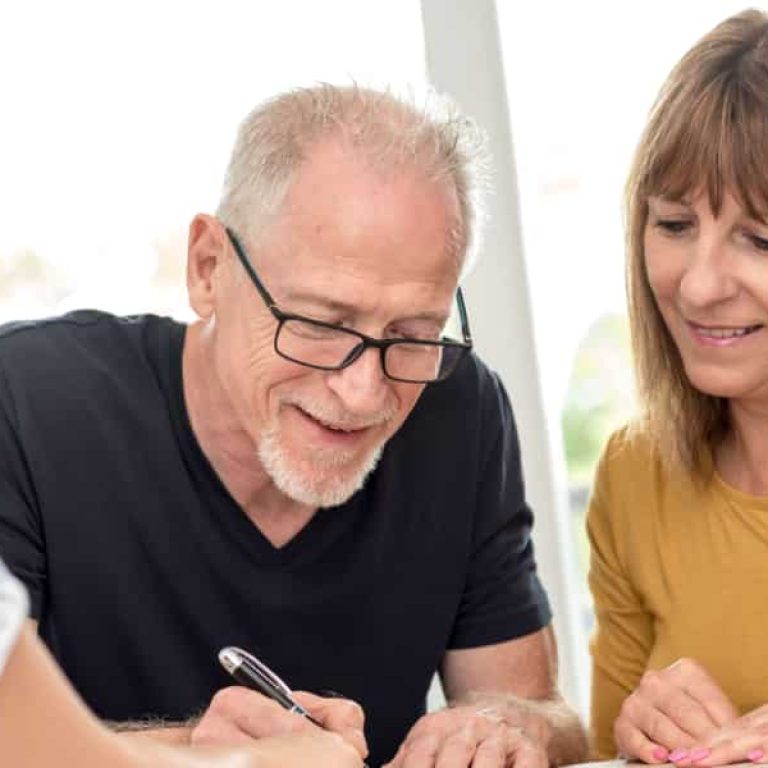 A couple signing an estate plan.