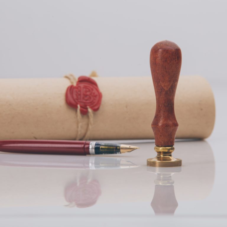 Fountain pen and old notarial wax seal on document