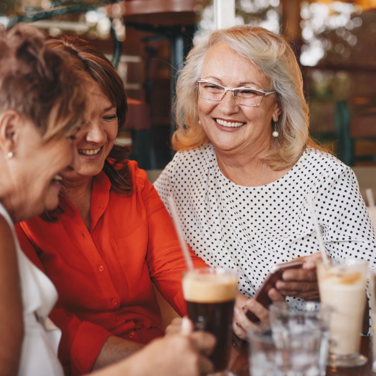 Senior ladies viewing photos on smart phone
