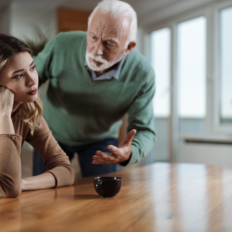 Mature father  arguing with his  adult daughter at home