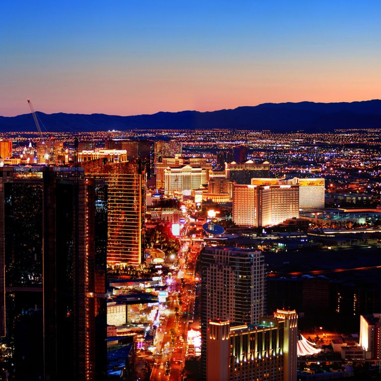 Las Vegas City Skyline panorama with sunset, mountain, luxury hotels and streets.